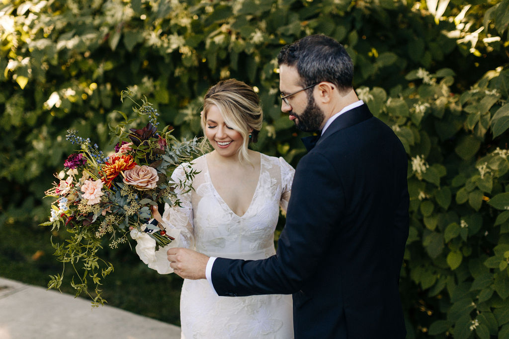 Bride showing the groom her bold and textural bridal bouquet