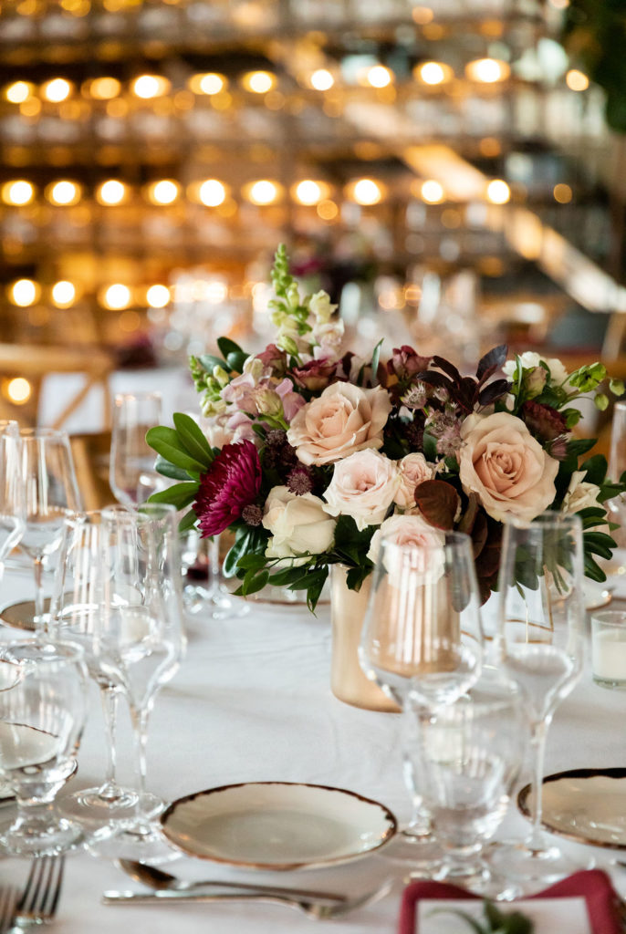 Burgundy reception table flower arrangement