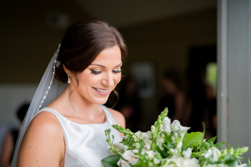 Chic and classy bride with cascading what and green bridal bouquet