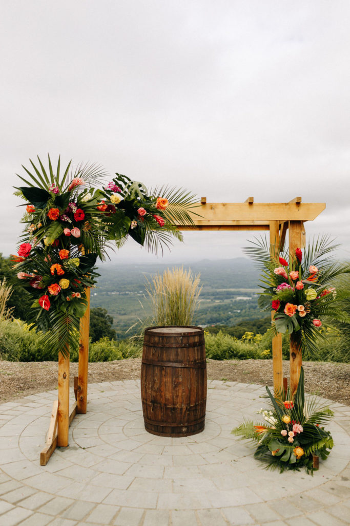 Vibrant tropical floral arch with a mountain view