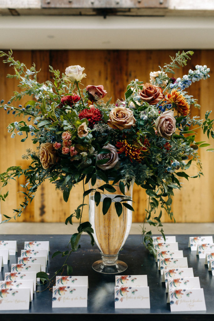 Earthy bold escort table flower arrangement
