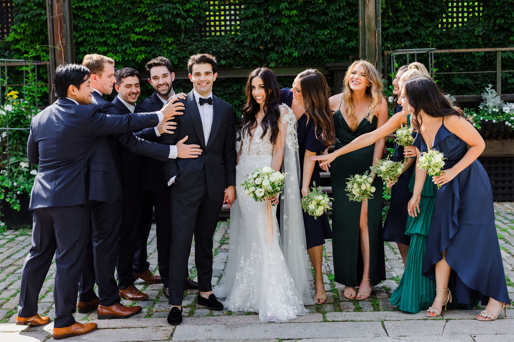 bridal party with white and green floral bouquets