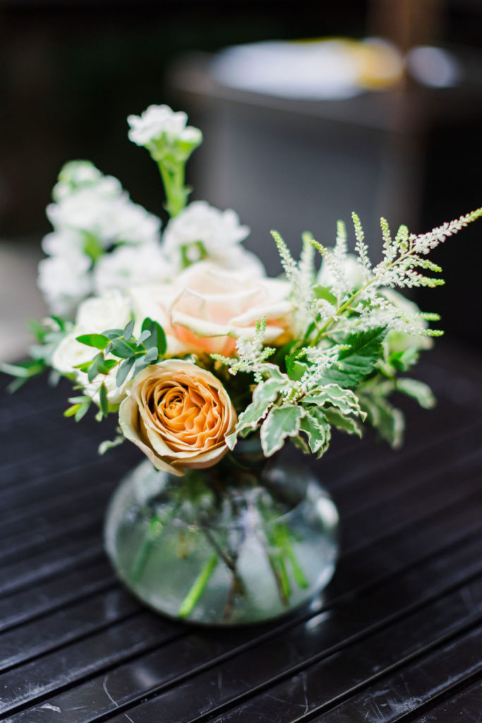 garden inspired floral arrangement with light greenery and roses