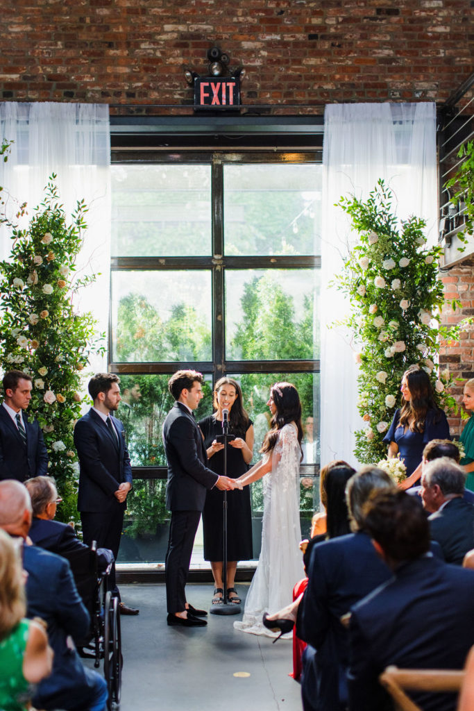 garden inspired wedding ceremony with floral pillars