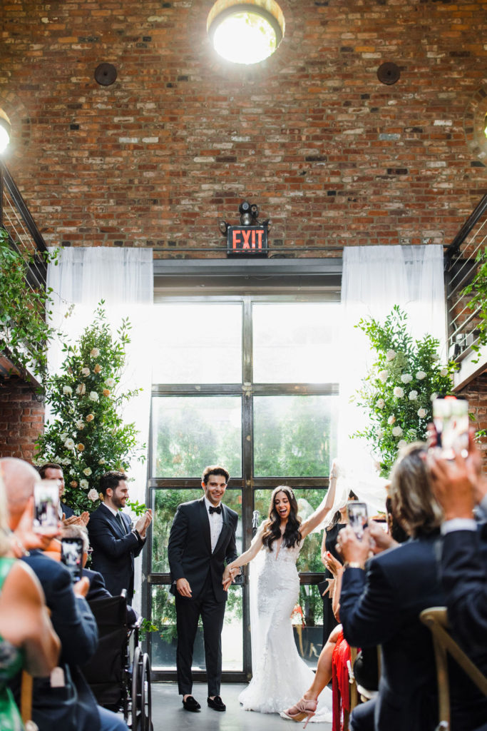 garden inspired wedding ceremony with floral pillars
