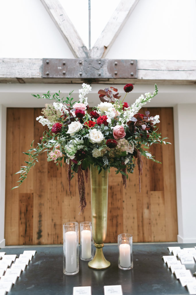 lush escort arrangement with burgundy and white florals