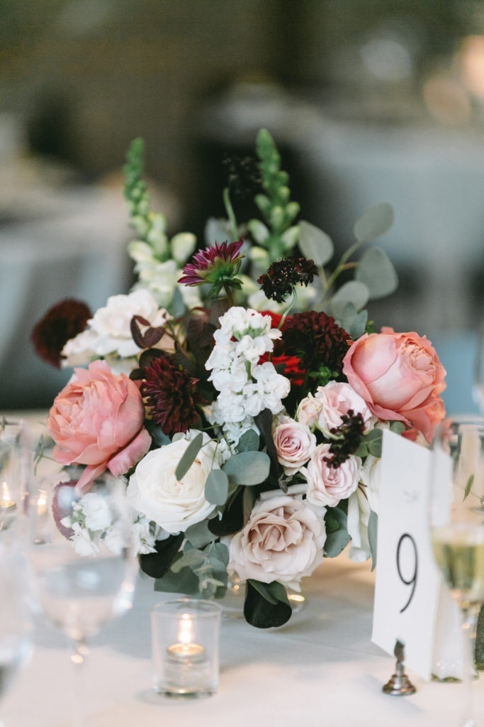 Burgundy and blush floral arrangement for wedding reception