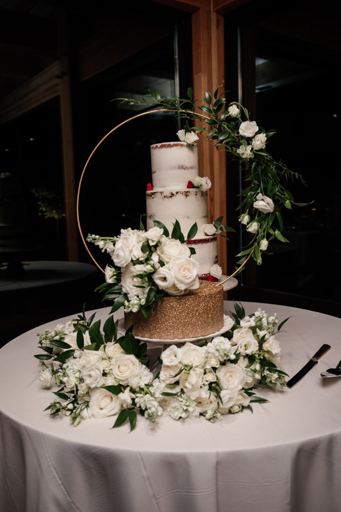 modern wedding cake with a floral hoop to accent