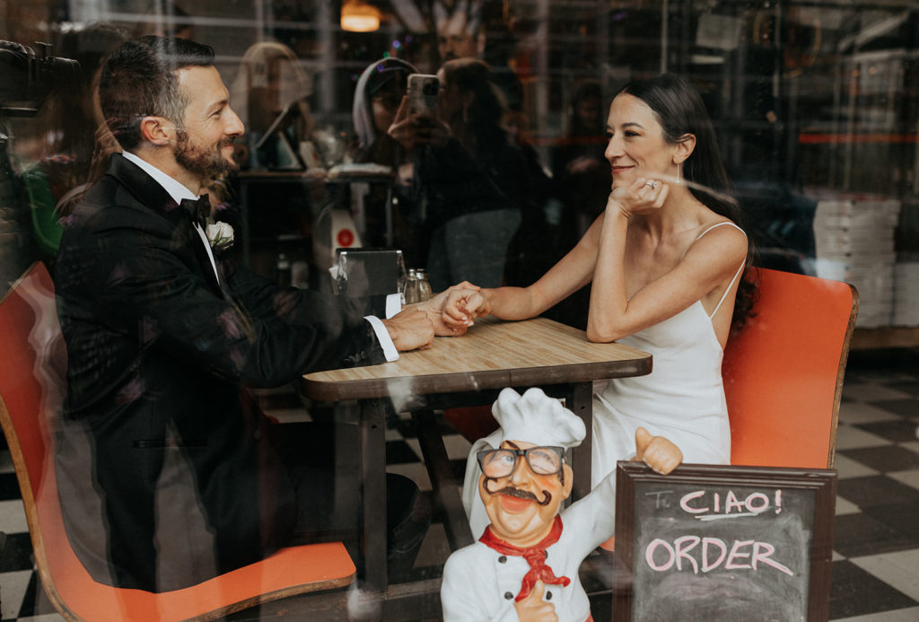 Bride and groom in a pizzeria in the city