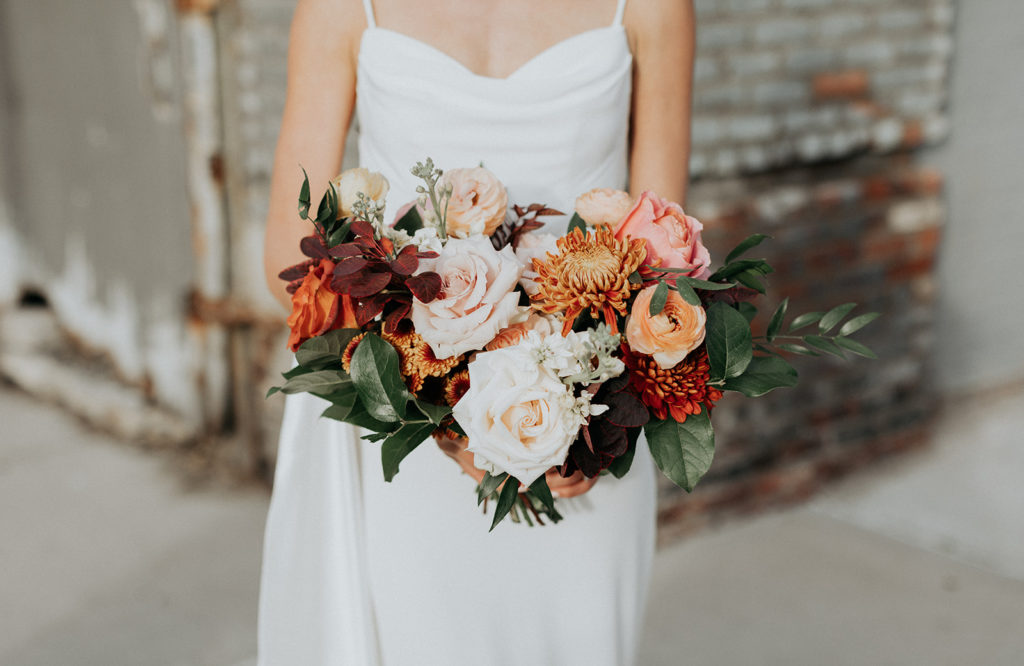 Fall bridal bouquet with mums, roses and ranunculus