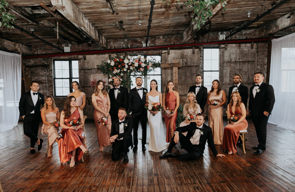 Fall City Wedding Bridal Party Posed in Front of Floral Arch