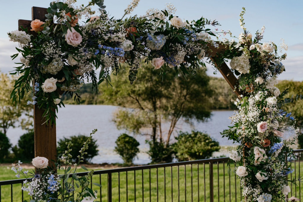 Floral wedding arch with hydrangea, roses and dephinium