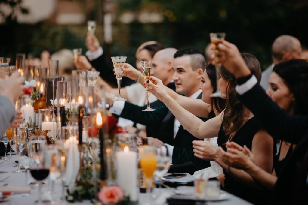 Wedding cheers with black taper candles and white hurricanes