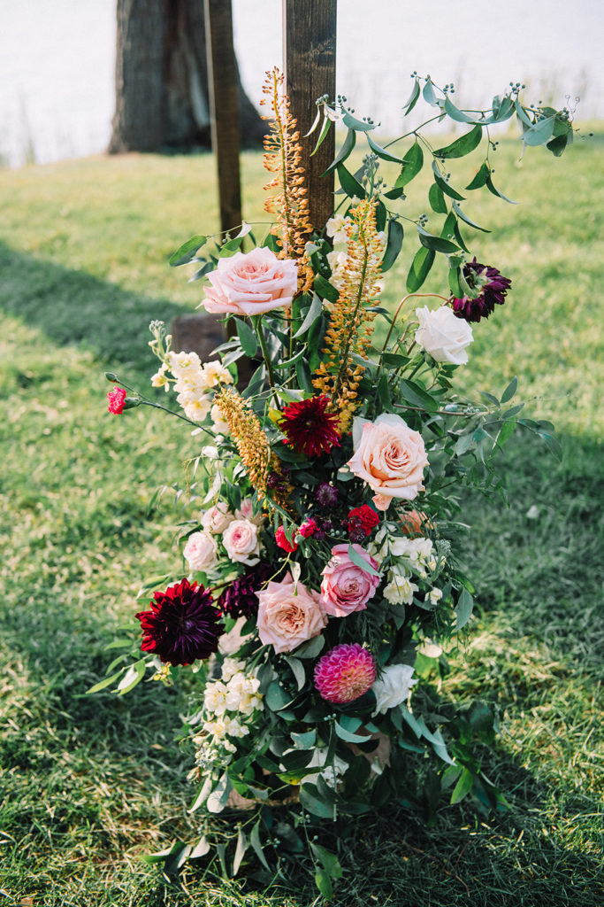 wedding chuppah with vibrant florals and lots of texture