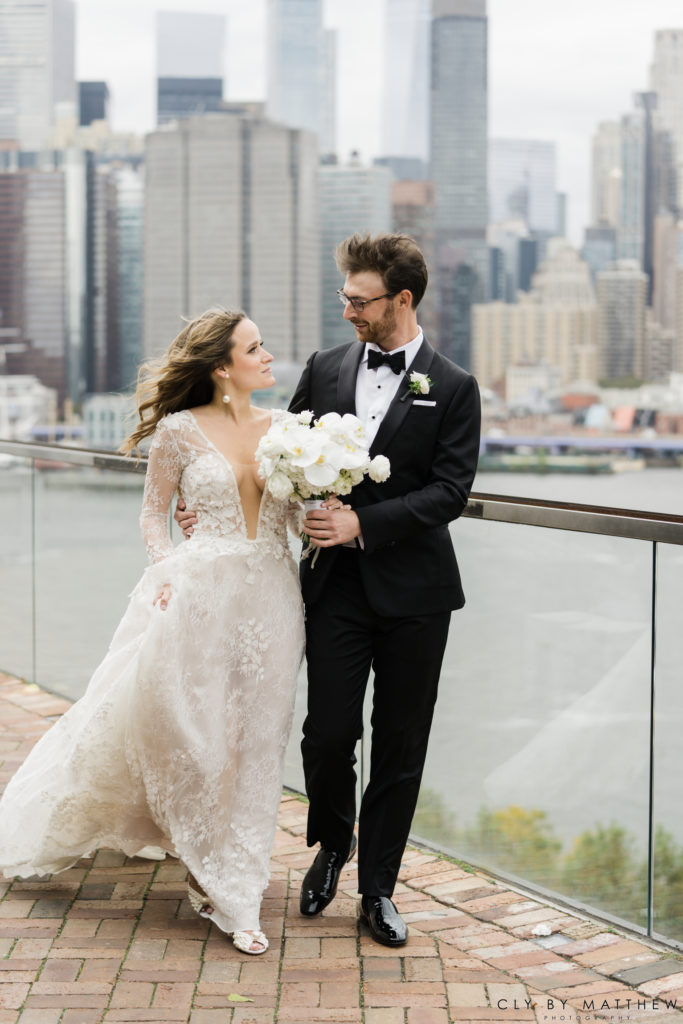 Chic city wedding Bride and Groom Walking with white and green bouquet