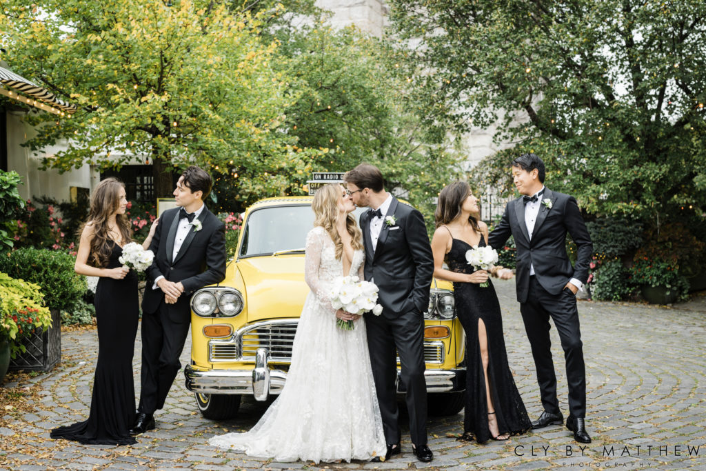 Bride and Groom and Bridal Party with Vintage Taxi for their Chic City Wedding