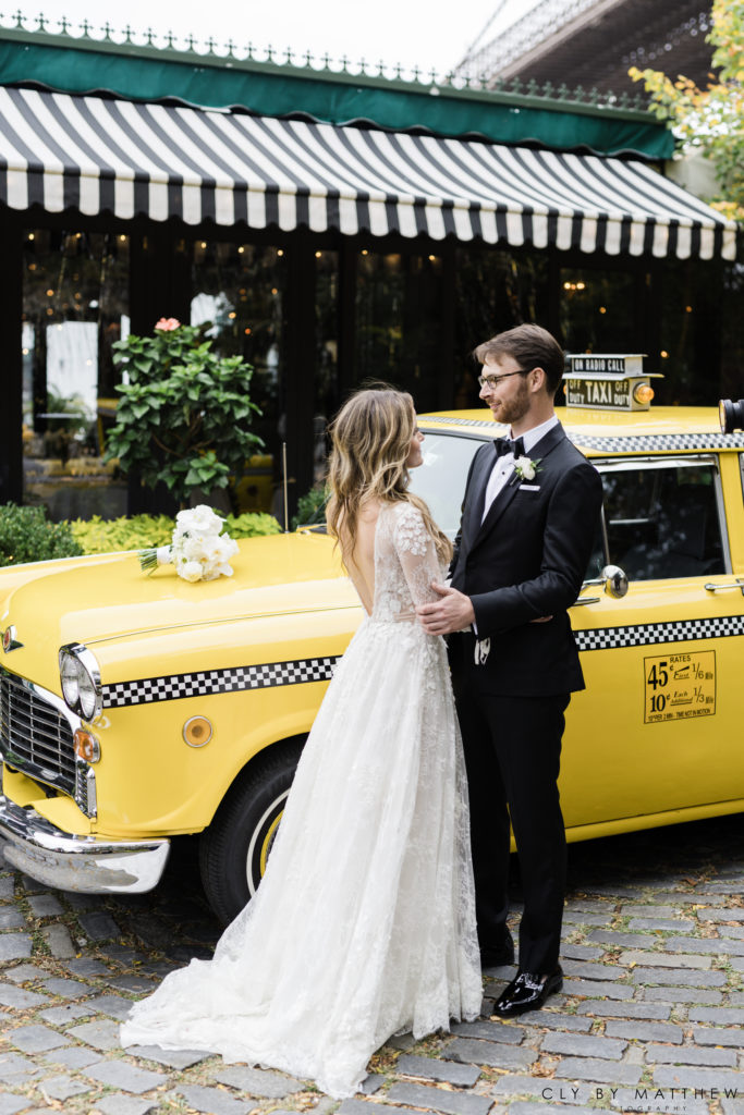Bride and Groom with Vintage Taxi for their Chic City Wedding