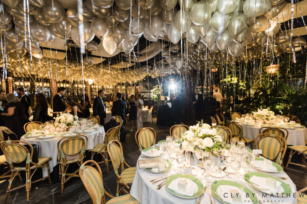 Chic city wedding reception tables under a Bollon covered ceiling