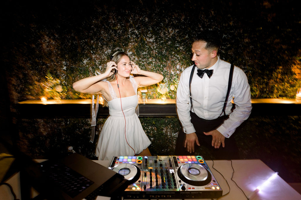 Bride and Groom behind DJ Booth. Wedding Blog.