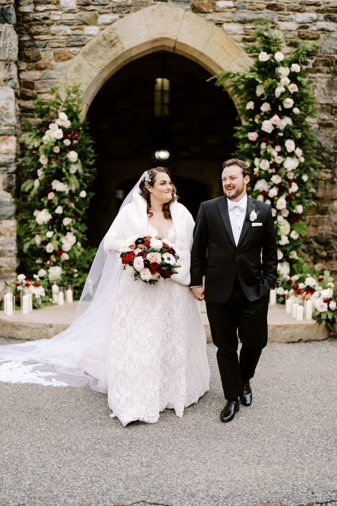 winter wedding bride and groom with floral pillars