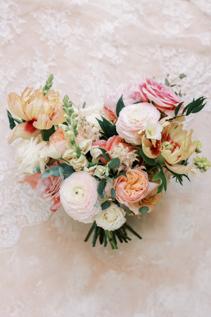 Spring wedding bridal bouquet with peonies and ranunculus